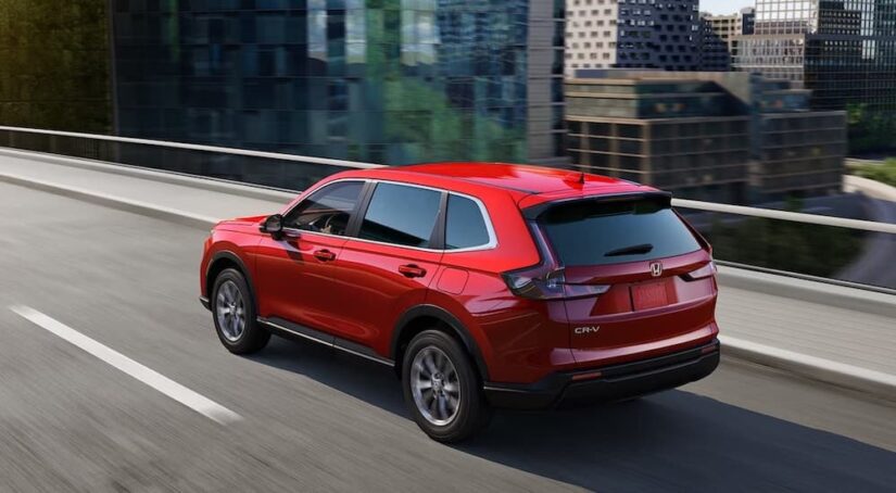 A red 2023 Honda CR-V is shown from the rear at an angle.