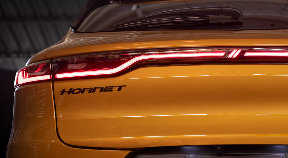 The Hornet badging on the rear of a yellow 2024 Dodge Hornet.