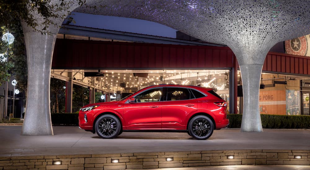 A red 2024 Ford Escape ST is shown from the side.