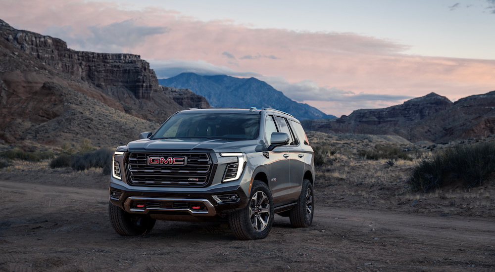 A grey 2025 GMC Yukon AT4 Ultimate is shown from the front at an angle after leaving a GMC dealer.