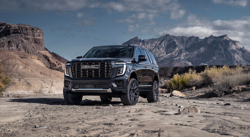 A black 2025 GMC Yukon Denali Ultimate is shown from the front at an angle.