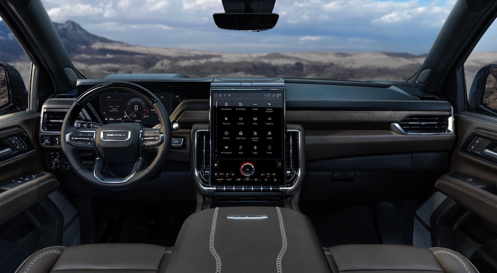 The black interior of a 2025 GMC Yukon Denali Ultimate is shown from above the center console.