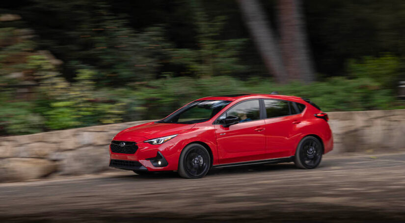 A red 2024 Subaru Impreza RS is shown from the side.