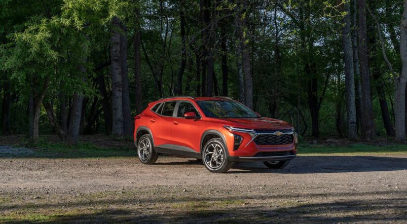 An orange 2024 Chevy Trax is shown from the front at an angle after leaving a Chevy dealer.