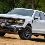 A white 2025 Ford F-150 Tremor is shown from the front at an angle.