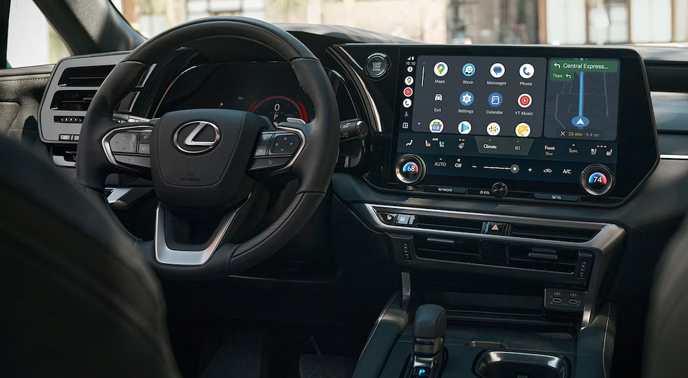 The steering wheel and infotainment screen in a 2024 Lexus RX for sale.