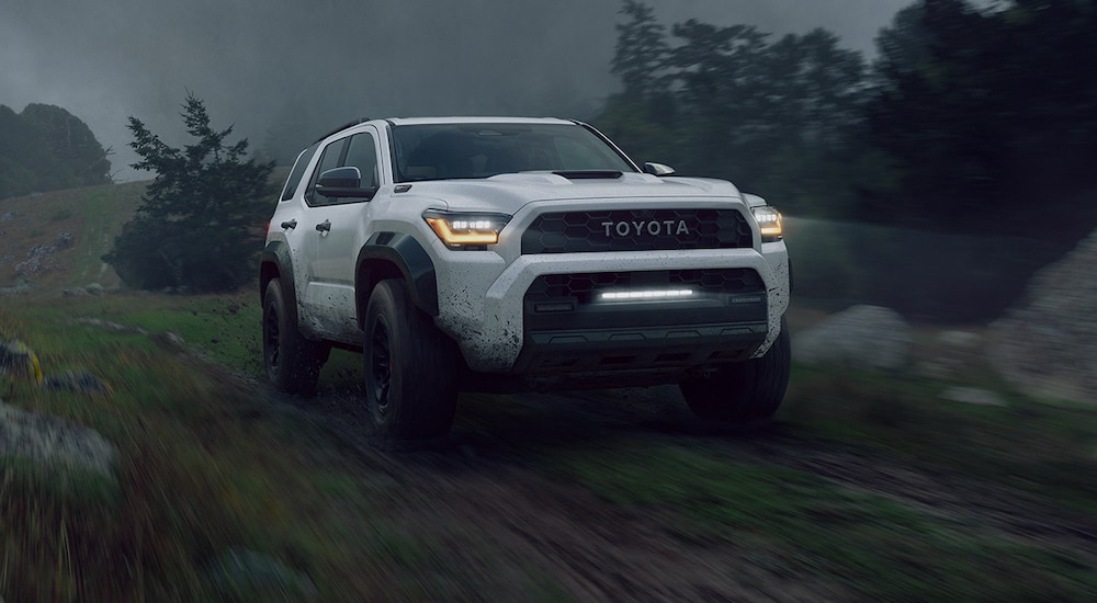 A white 2025 Toyota 4Runner TRD Pro driving down a road.