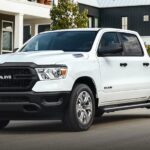 A white 2021 Ram 1500 is shown parked after viewing used trucks for sale.