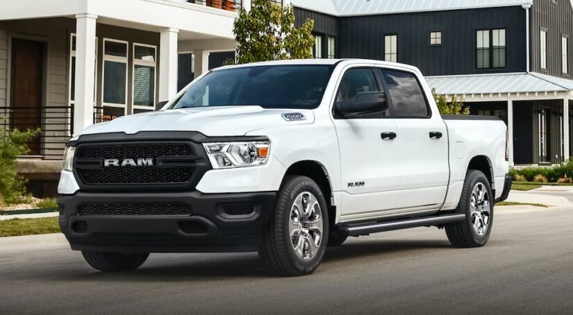 A white 2021 Ram 1500 is shown parked after viewing used trucks for sale.