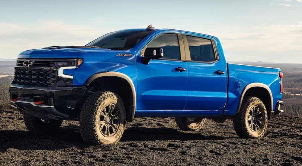 A blue 2025 Chevy Silverado 1500 ZR2 is shown parked off-road.