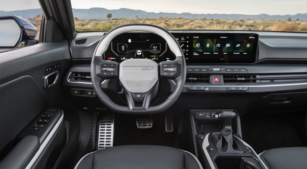 The interior of a 2025 Kia K4 is shown from the driver's seat.