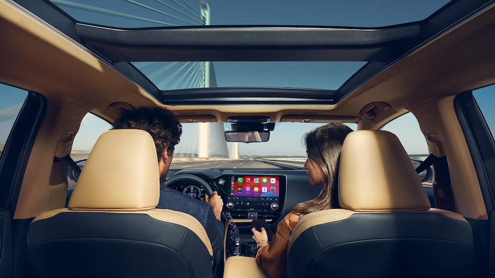 The black and tan interior and dash in a 2025 Lexus NX 450+ is shown.