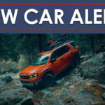 An orange 2026 Honda Passport Trailsport is shown from the front at an angle.