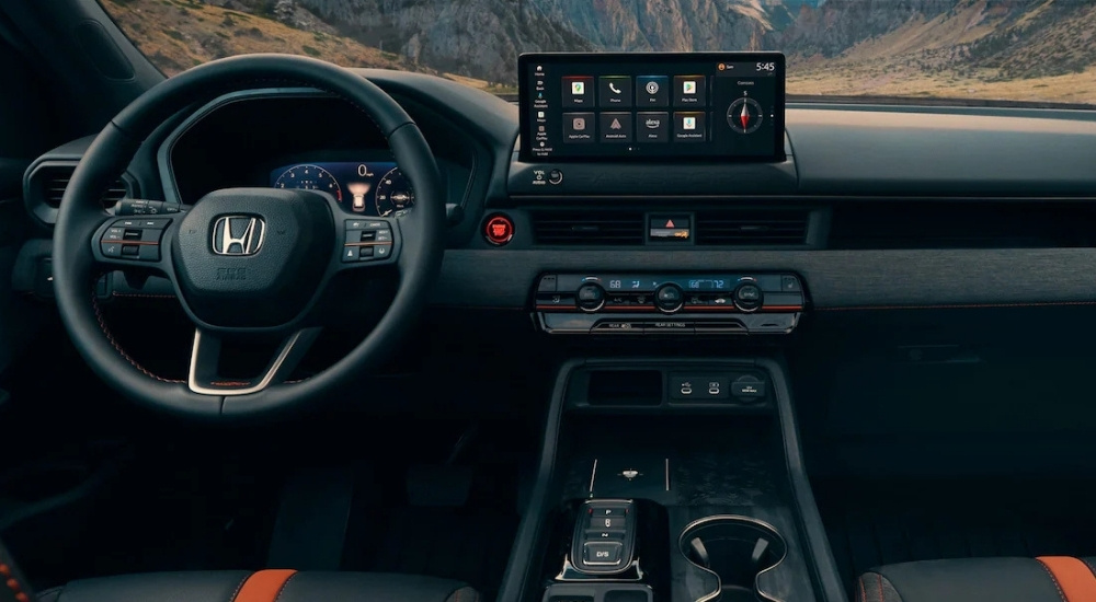 The black interior of a 2026 Honda Passport Trailsport is shown from above the center console.