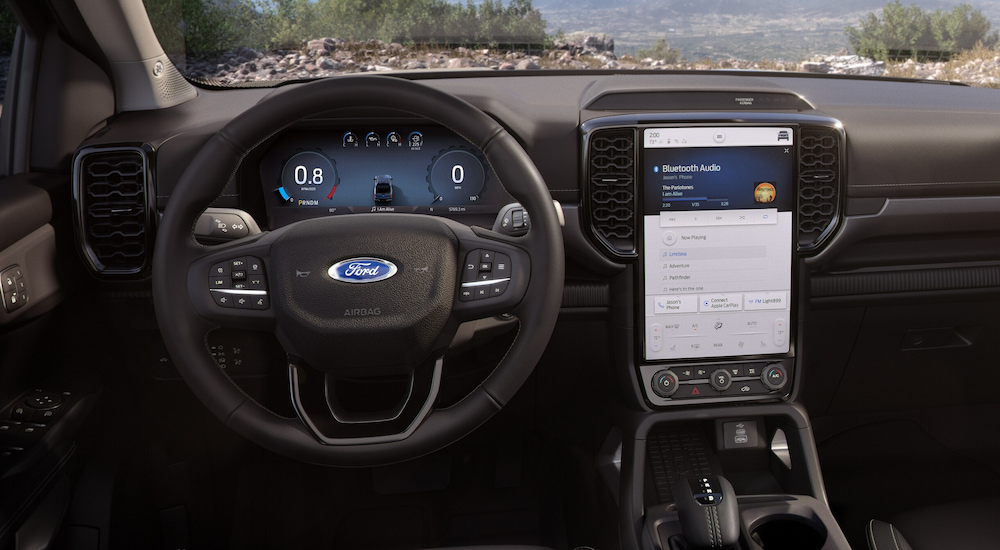 The steering wheel and infotainment screen in a 2024 Ford Ranger at a Ford dealer.