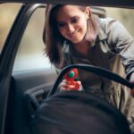 A mother is shown installing a car seat in a vehicle.