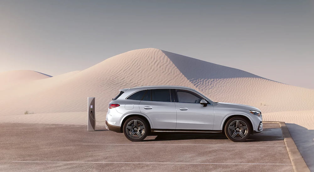 Side angle view of a white 2025 Mercedes-Benz GLC parked in a desert.