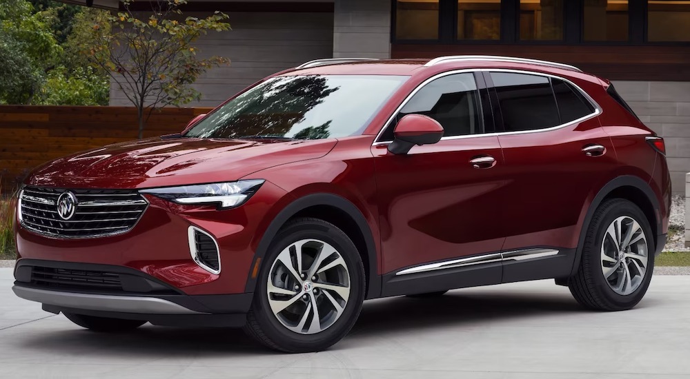 A red 2024 Buick Envision is shown parked outside a building.