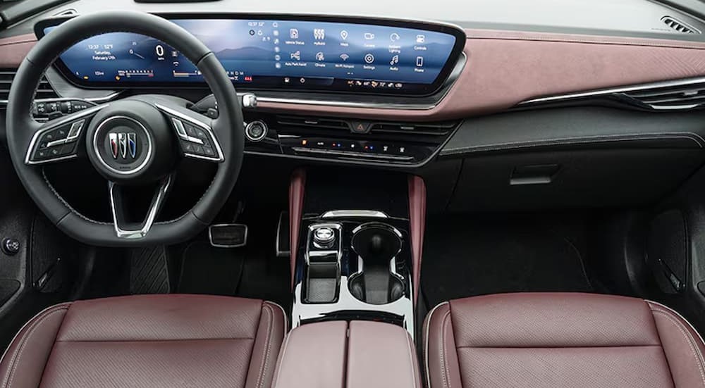 The black and red interior and dash are shown in a 2025 Buick Envision ST.