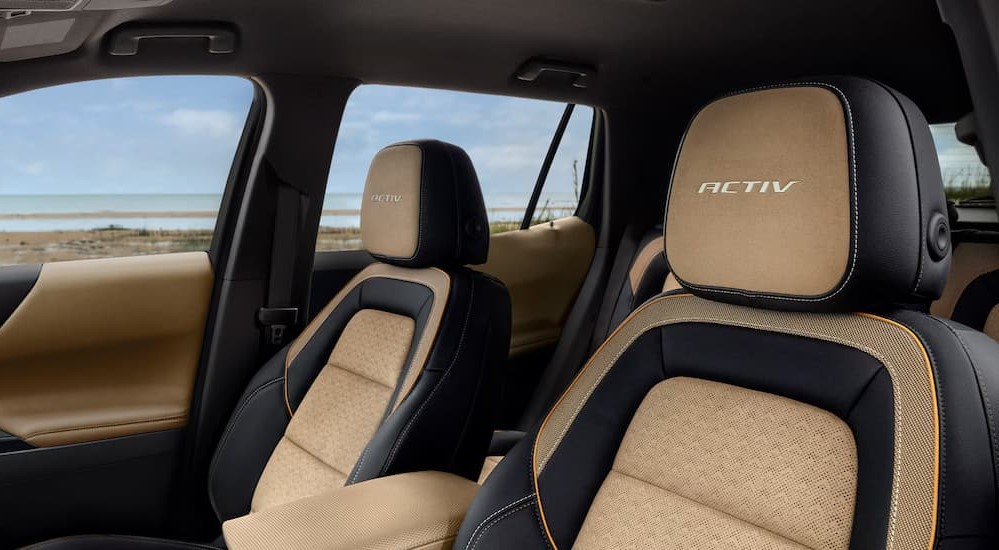 The black and tan interior is shown in a 2025 Chevy Equinox ACTIV.