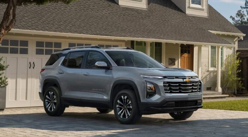 A silver 2025 Chevy Equinox LT is shown parked on a driveway.