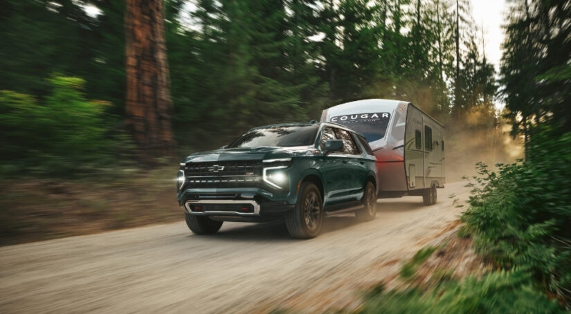 A green 2025 Chevy Tahoe Z71 is shown from the front at an angle.