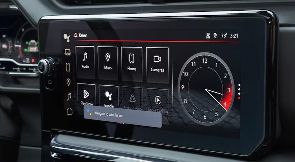 A close-up of the infotainment screen is shown in a 2025 GMC Sierra 1500.