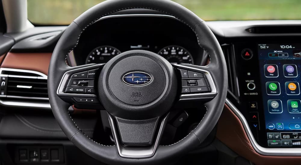 A close-up of a steering wheel is shown in a 2025 Subaru Outback for sale.