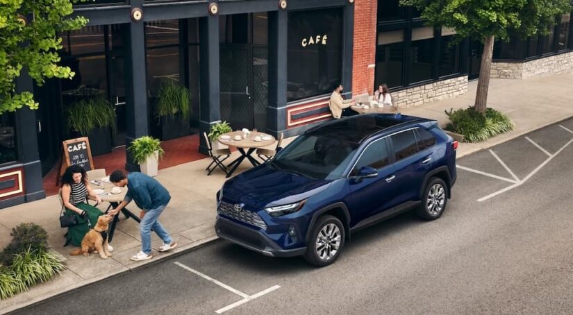 A blue 2025 Toyota RAV4 is shown parked after visiting a Toyota dealer.