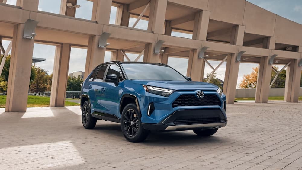 A light blue 2025 Toyota RAV4 Hybrid is shown parked outdoors.