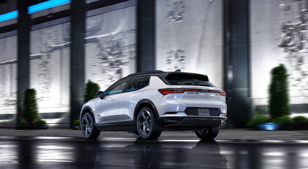 A white 2025 Chevy Equinox EV 3RS is shown from the rear at an angle.