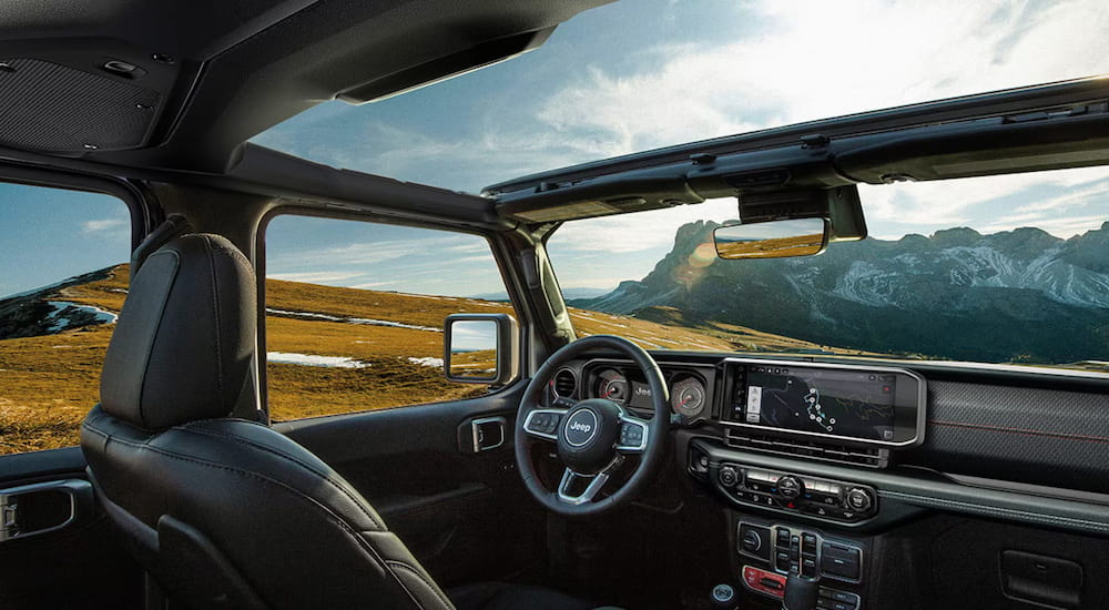 The black interior of a 2025 Jeep Wrangler with an open top.