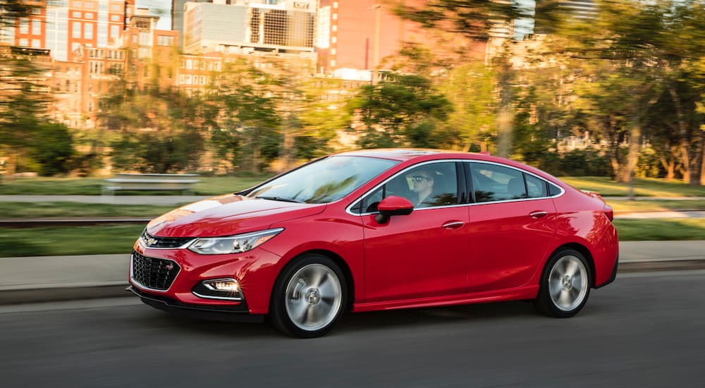 A red 2016 Chevy Cruze is shown from the side.