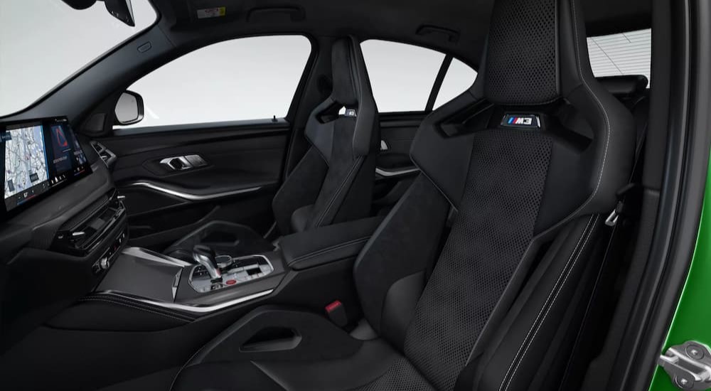 The black interior and dash are shown in a 2025 BMW M3.