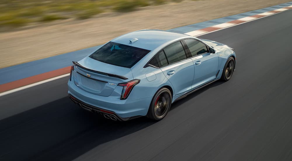 A light blue 2025 Cadillac CT5-V Blackwing driving on a track.