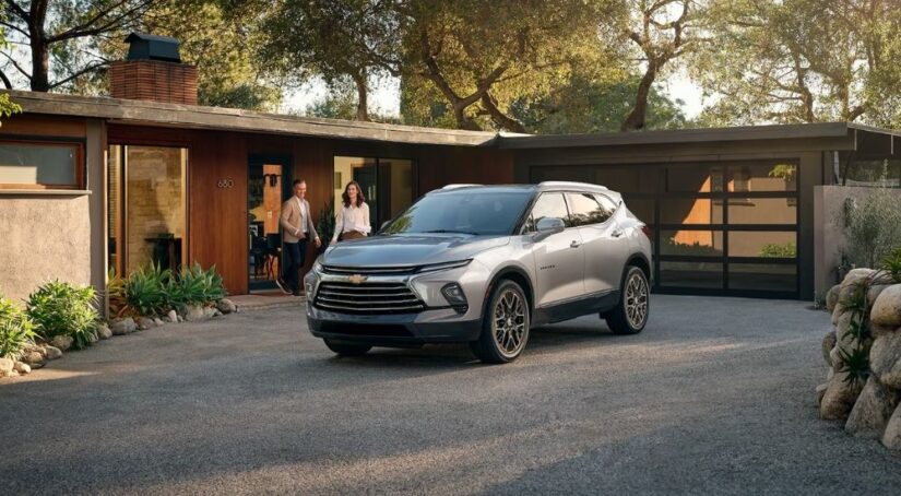 A silver 2025 Chevy Blazer Premier parked in the driveway of a modern home.