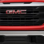 Close-up of the grille on a red 2025 GMC Sierra Pro.