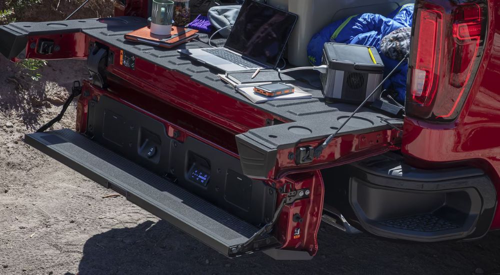 The open MultiPro tailgate of a red 2025 GMC Sierra 1500 Pro.