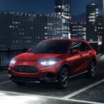 A red 2025 Honda HR-V EX-L parked in a parking lot.