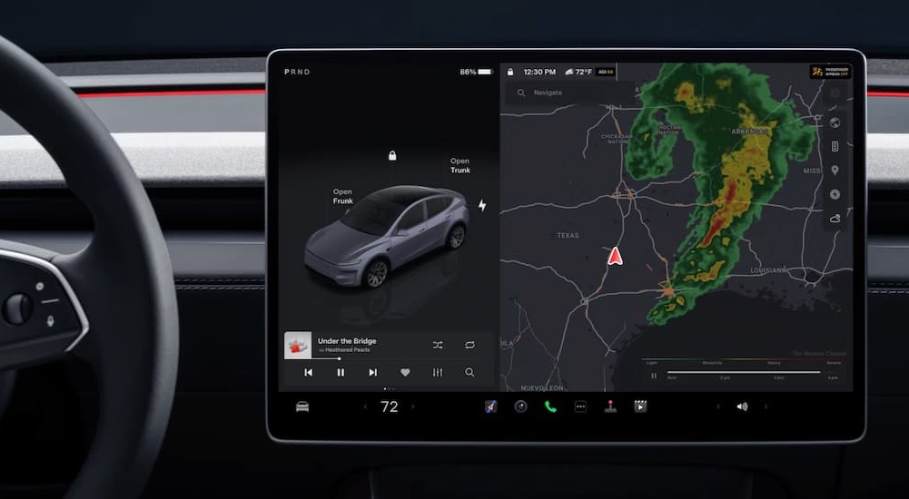 A close-up of the infotainment screen is shown in a 2025 Tesla Model Y.