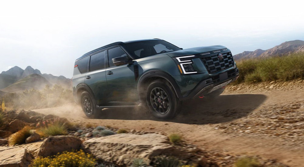 A green 2025 Nissan Armada Pro-4X is shown off-roading.