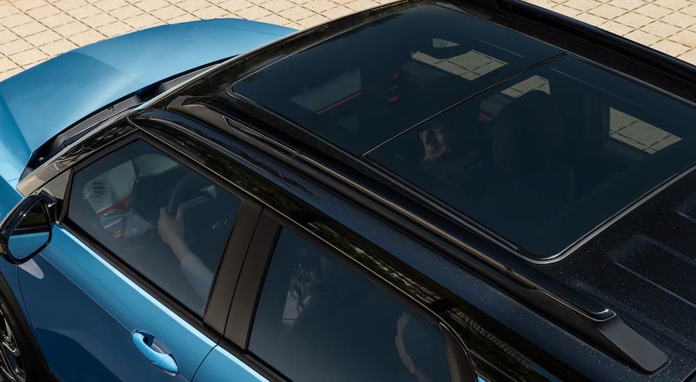 A close-up of the sunroof on a blue 2025 Chevy Trailblazer RS is shown.