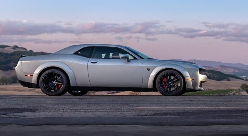 A silver 2020 Dodge Challenger SRT Hellcat is shown at dusk.