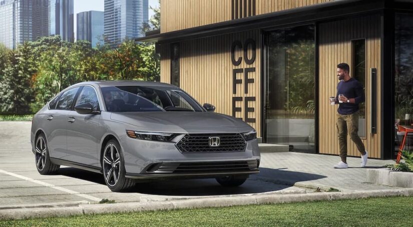 A grey 2025 Honda Accord Hybrid for sale is shown from the front at an angle.