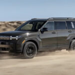 A grey 2025 Hyundai Santa Fe for sale is shown off-road.