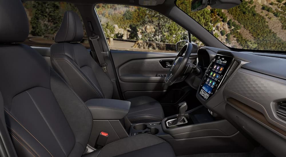 The black and gray interior and dash are shown in a 2025 Subaru Forester Hybrid.