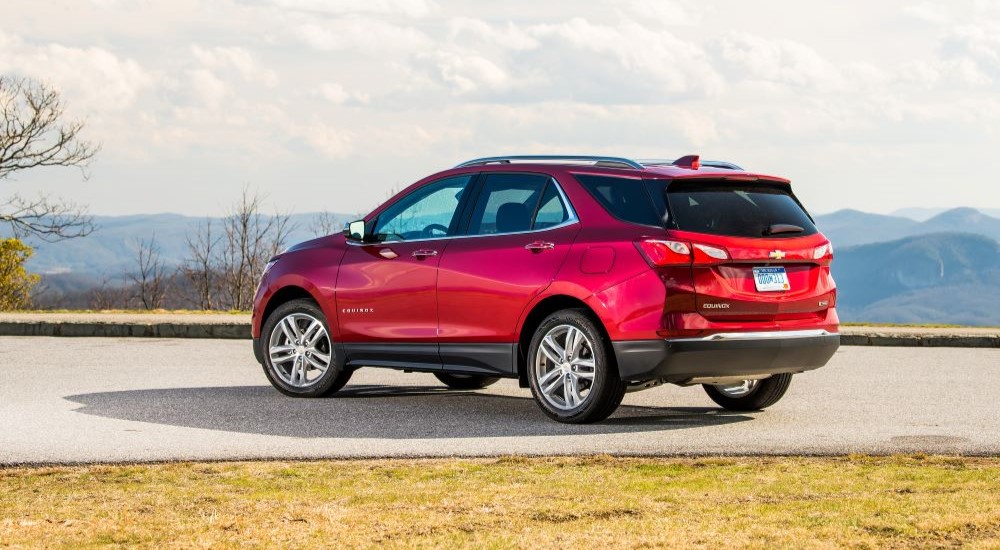 A red 2019 Chevy Equinox is shown parked on a sunny day.