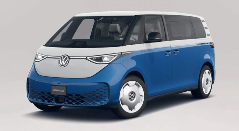 A white and blue 2025 Volkswagen ID. Buzz is shown parked on a showroom floor.