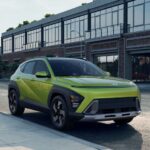 A bright green 2025 Hyundai Kona for sale parked on a city street.