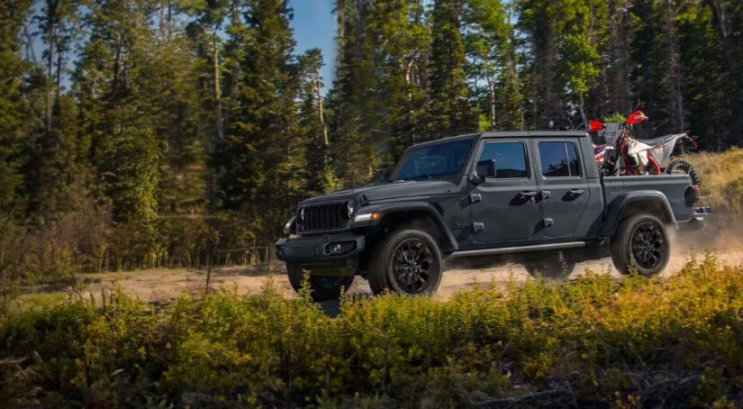 A grey 2025 Jeep Gladiator Nighthawk is shown off-road.